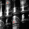 A row of at least fourteen beer cans, stacked two-high